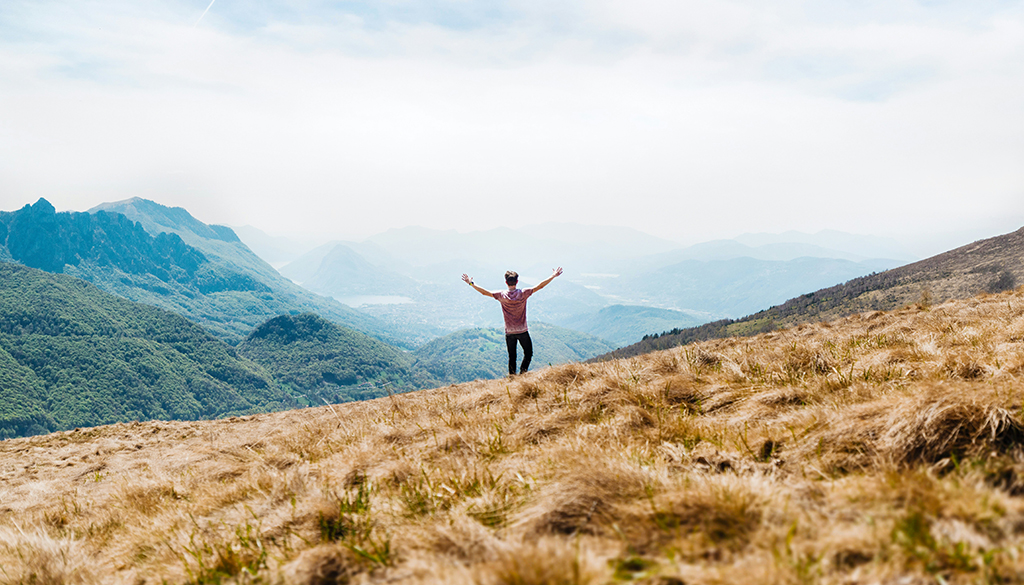 person standing with hands in the air