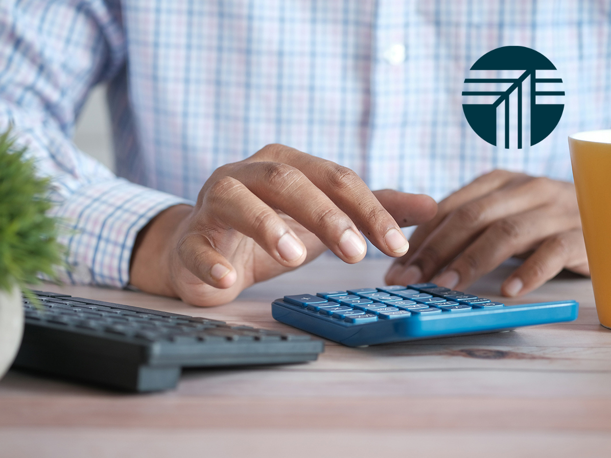 hands typing on calculator