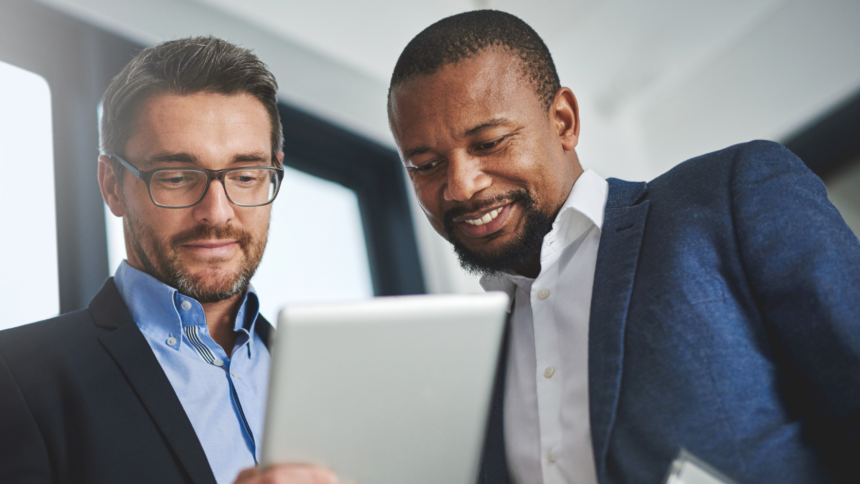 Professionals reviewing new investment opportunities on a laptop