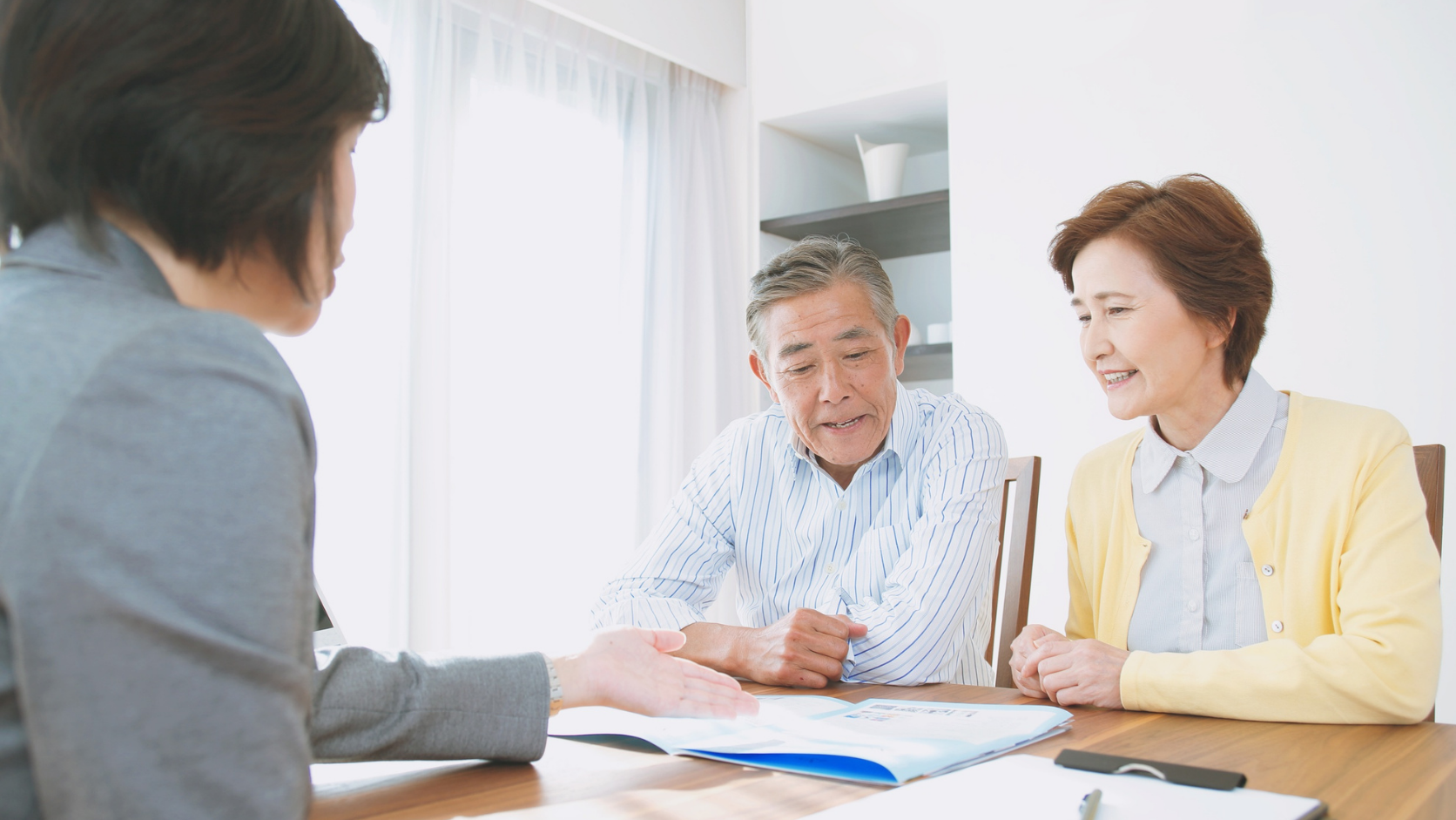 Older couple reviewing financial documents with an advisor